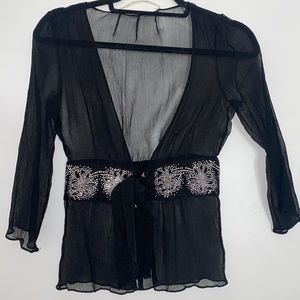 Black sheer blouse is good condition but missing 1 button